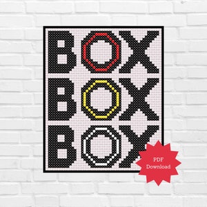 May include: A cross-stitch pattern featuring the word "BOX" repeated three times, with each "O" in a different color: red, yellow, and white. The pattern is on a pink background and has a black border. A red star with the text "PDF Download" is in the lower right corner.