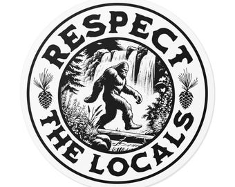 May include: Black and white sticker with a circle design. The text "Respect the Locals" is written in a circle around a black and white illustration of a Bigfoot walking through a forest with a waterfall in the background.