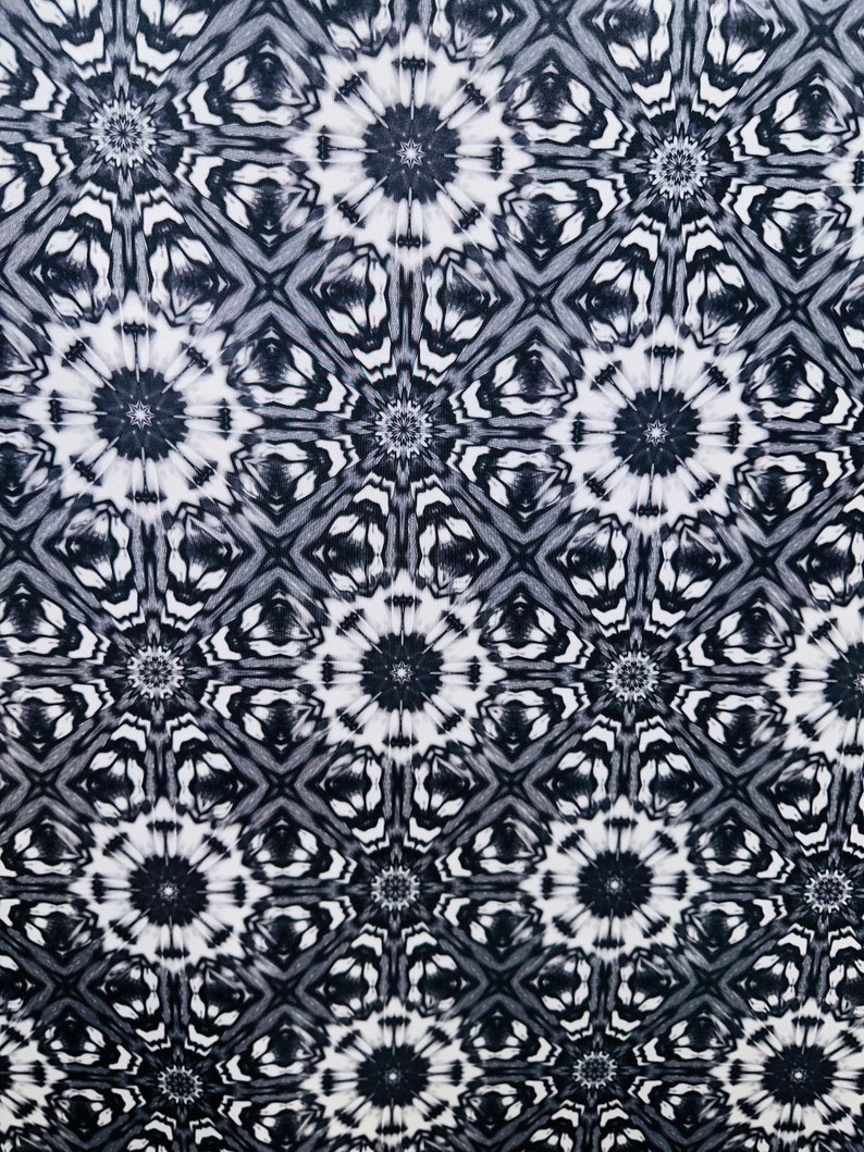 May include: Black and white abstract pattern with a repeating geometric design. The pattern features a series of interlocking circles and squares.
