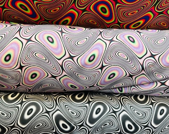 May include: Four rolls of fabric with a swirling, psychedelic pattern. The fabric is in four different color combinations: red and blue, white and purple, black and white, and yellow and pink.