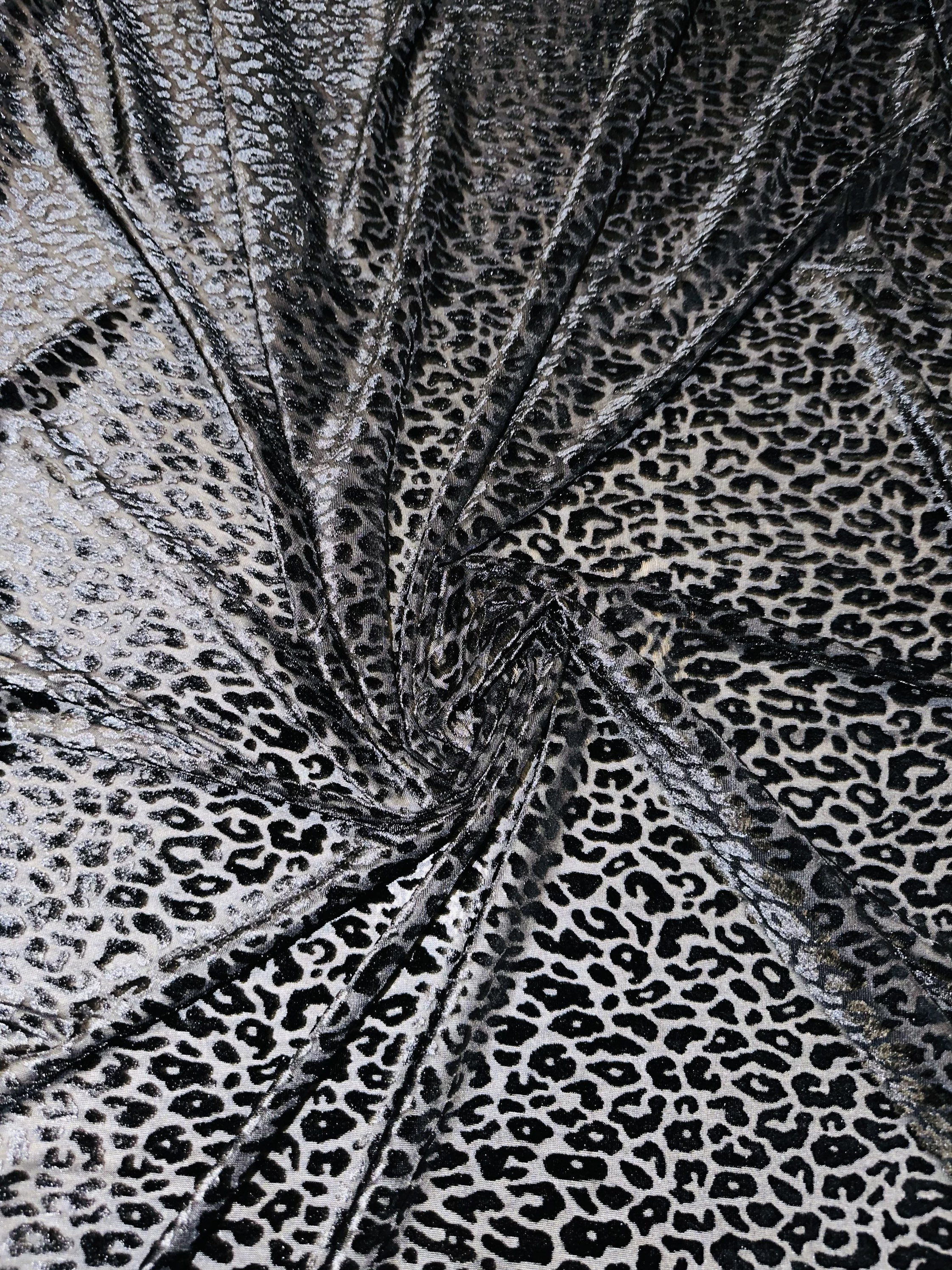 Exotic cheetah design luxury black burnout stretch velvet 4-way stretch 58/60” Sold by the YD. High quality fabric in the market.