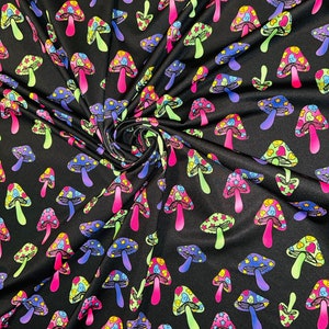 New Magic Mushrooms design Black/Multicolor print on jumbo nylon spandex 4-way stretch 58/60” Sold by the YD.