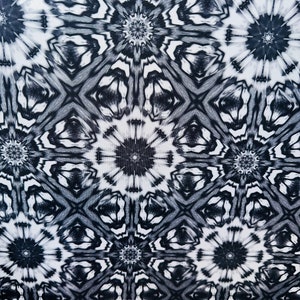 May include: Black and white abstract pattern with a repeating geometric design. The pattern features a series of interlocking circles and stars.