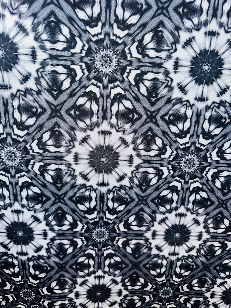 May include: Black and white abstract pattern with a repeating geometric design. The pattern features a series of interlocking circles and stars.