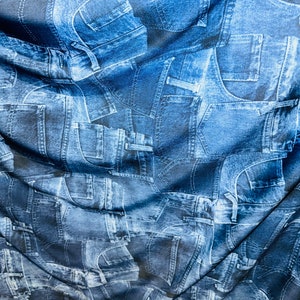 New Denim pockets design Blue Color print on great quality of Poly spandex 4-way stretch 58/60” Sold by the YD.