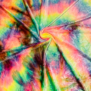 May include: A vibrant, swirled fabric with a tie-dye pattern. The textile features a spectrum of colors, including pink, yellow, green, blue, and brown. The fabric is gathered in a spiral, creating a dynamic visual effect.