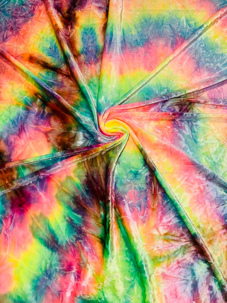 May include: A vibrant, swirled fabric with a tie-dye pattern. The textile features a spectrum of colors, including pink, yellow, green, blue, and brown. The fabric is gathered in a spiral, creating a dynamic visual effect.