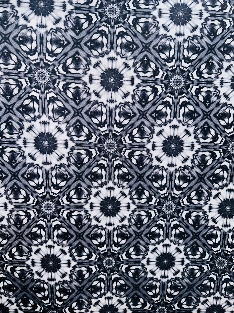 May include: Black and white abstract pattern with a repeating geometric design. The pattern features a series of interlocking circles and squares.