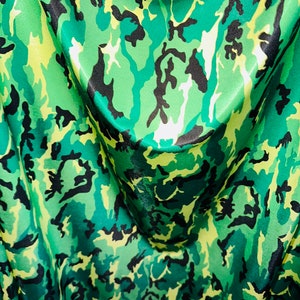 Camouflage design green multi print on great quality of nylon spandex 4-way stretch 58/60” Sold by the YD.
