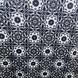 May include: Black and white fabric with a repeating geometric pattern. The pattern features a series of interlocking stars and diamonds.