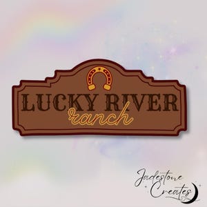 May include: A brown wooden sign with a gold horseshoe and the text "LUCKY RIVER ranch" in white and gold lettering.
