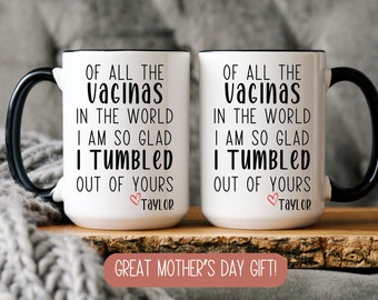 May include: Two white coffee mugs with black handles. The mugs have the text "OF ALL THE vacunas IN THE WORLD I AM SO GLAD I TUMBLED OUT OF YOURS TAYLOR" printed on them.  Great Mother's Day Gift! is printed below the mugs.