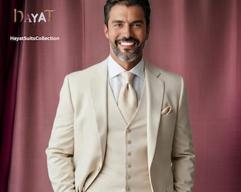 May include: A man wearing a light beige suit with a vest and a light beige patterned tie. The suit has a pocket square. The background is a pink curtain with the text "HAYAT HayatSuitsCollection".