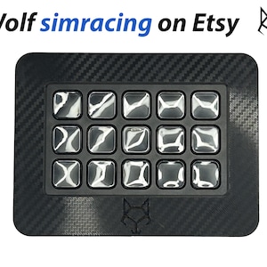 May include: A black button box with a carbon fibre texture and 16 clear buttons. The box has a wolf logo on the front.
