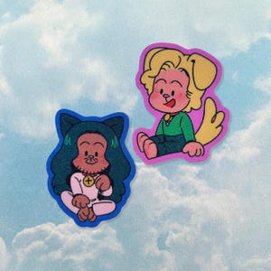 May include: Two cartoon stickers on a cloudy background. One sticker features a person with cat ears, blue hair, and a pink outfit. The other sticker depicts a dog-like character in a green shirt and blue pants, with a pink border.