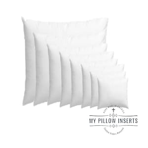 May include: A set of seven white pillow inserts of various sizes, stacked on top of each other. The inserts are made in America and are for custom orders. The text "My Pillow Inserts" is displayed on a label below the pillows.