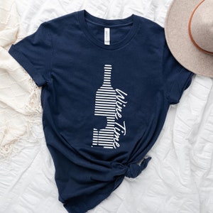 May include: A navy blue t-shirt with a white striped wine bottle graphic and the text "Wine Time" in white.