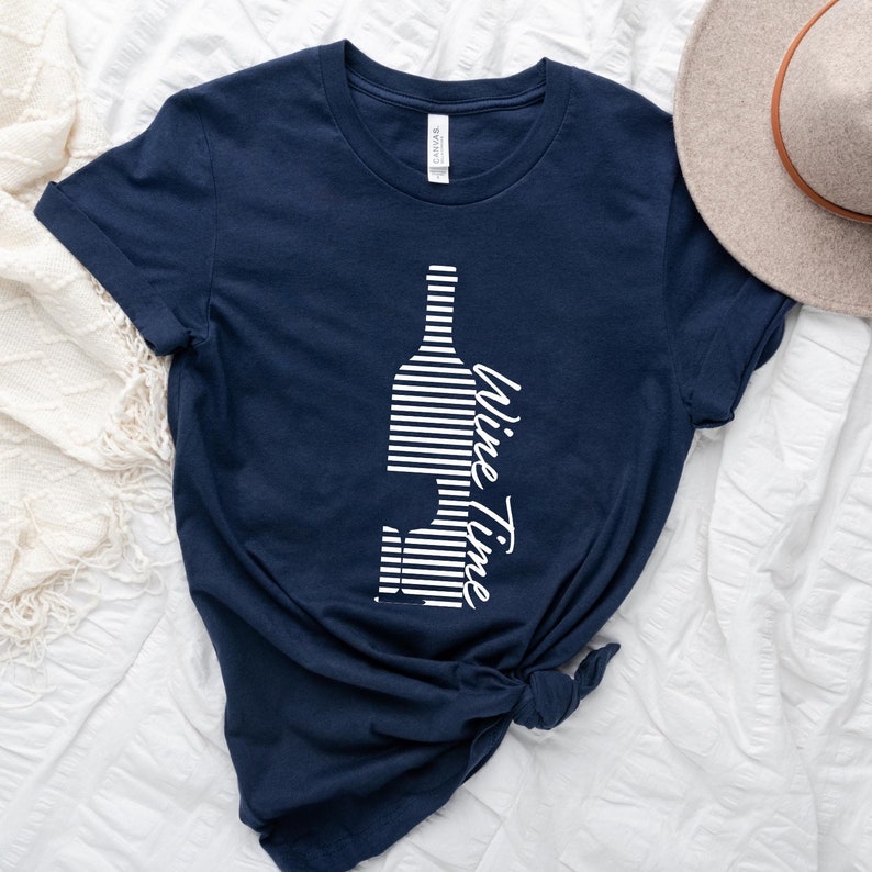 May include: A navy blue t-shirt with a white striped wine bottle graphic and the text "Wine Time" in white.