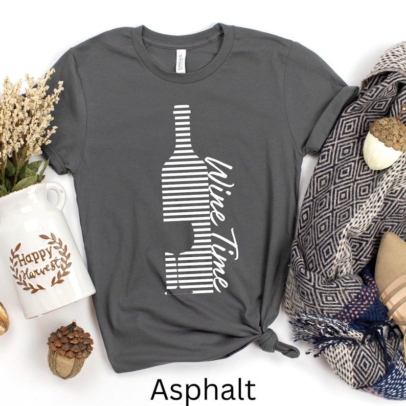 May include: A gray t-shirt with a white striped wine bottle and glass graphic and the text "Wine Time".