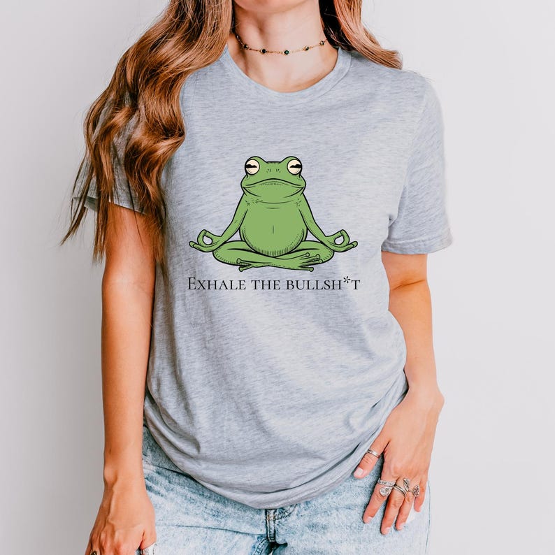 May include: A gray t-shirt with a green frog meditating and the text "Exhale the Bullsh*t".