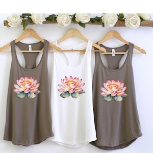 May include: Three tank tops with a watercolor lotus flower design. The tank tops are in brown, white, and brown.