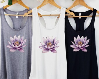 May include: Three tank tops with a purple lotus flower graphic. The tank tops are in gray, white, and black.