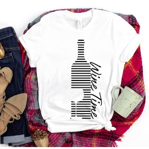 May include: White t-shirt with a black and white striped wine bottle graphic and the text "Wine Time" printed on the side.