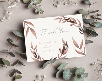 May include: A white thank you card with brown floral illustrations and the text "Thank You for showering blank with love".