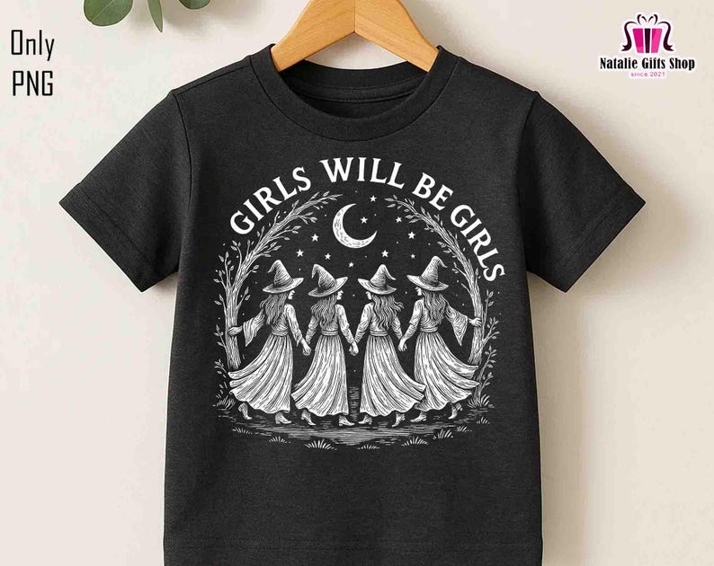 May include: Black t-shirt with the text "GIRLS WILL BE GIRLS" in a circular design. The graphic shows four figures in witch hats and dresses holding hands under a crescent moon and stars. The t-shirt is displayed on a wooden hanger.