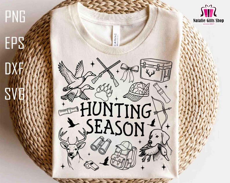 May include: Cream-colored t-shirt with a black and white hunting-themed graphic. The design includes ducks, rifles, a deer, a dog, and the words "HUNTING SEASON". The shirt also has the text "PNG EPS DXF SVG".