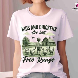 May include: A white t-shirt with a green and black illustration of a child and chickens in a field. The text "Kids and Chickens are best Free Range" is printed on the shirt.
