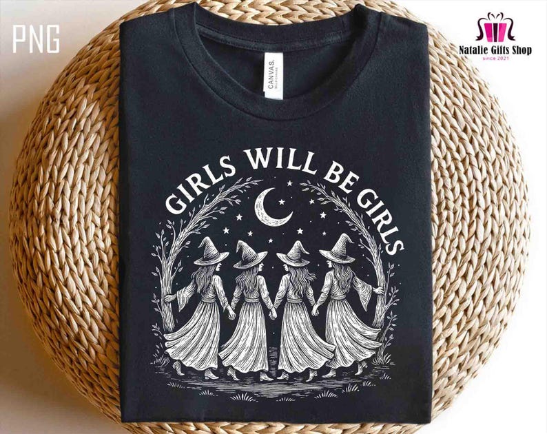 May include: Black t-shirt with the text "GIRLS WILL BE GIRLS" in white. The design features four witch figures holding hands under a crescent moon and stars. The shirt is made of a soft material.