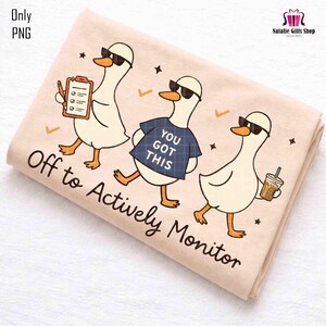 May include: A beige towel featuring three cartoon geese wearing sunglasses. One goose holds a clipboard, another wears a blue shirt with "YOU GOT THIS," and the third holds a coffee. The text "Off to Actively Monitor" is printed on the towel.