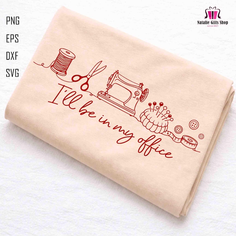 May include: A folded beige fabric with a red line drawing of sewing tools, including a spool of thread, scissors, a sewing machine, a pincushion, buttons, and a measuring tape. The text "I'll be in my office" is also included.