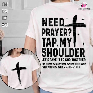May include: White t-shirt with a black cross graphic and the text "NEED PRAYER? TAP MY SHOULDER". The shirt also includes the quote "LET'S TAKE IT TO GOD TOGETHER. FOR WHERE TWO OR THREE GATHER IN MY NAME, THERE AM I WITH THEM. - Matthew 18:20."