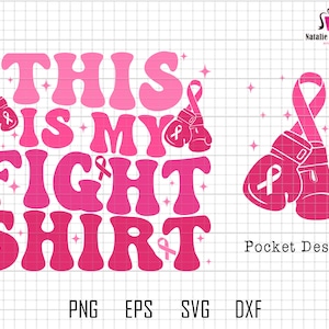 May include: Pink and white graphic design with the text "This is my fight shirt" in a retro font. The design includes pink boxing gloves with a pink ribbon on each glove. The design is suitable for a t-shirt or other apparel.
