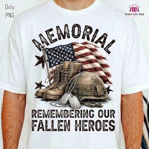 May include: White t-shirt with a patriotic design. The word "MEMORIAL" is above an American flag, combat boots, a helmet, and dog tags. The text "REMEMBERING OUR FALLEN HEROES" is printed below the graphic.