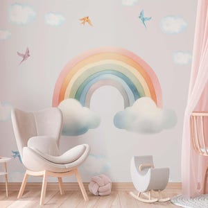 May include: A pastel rainbow with clouds and birds on a light pink wall. A rocking horse and a chair are in the foreground.