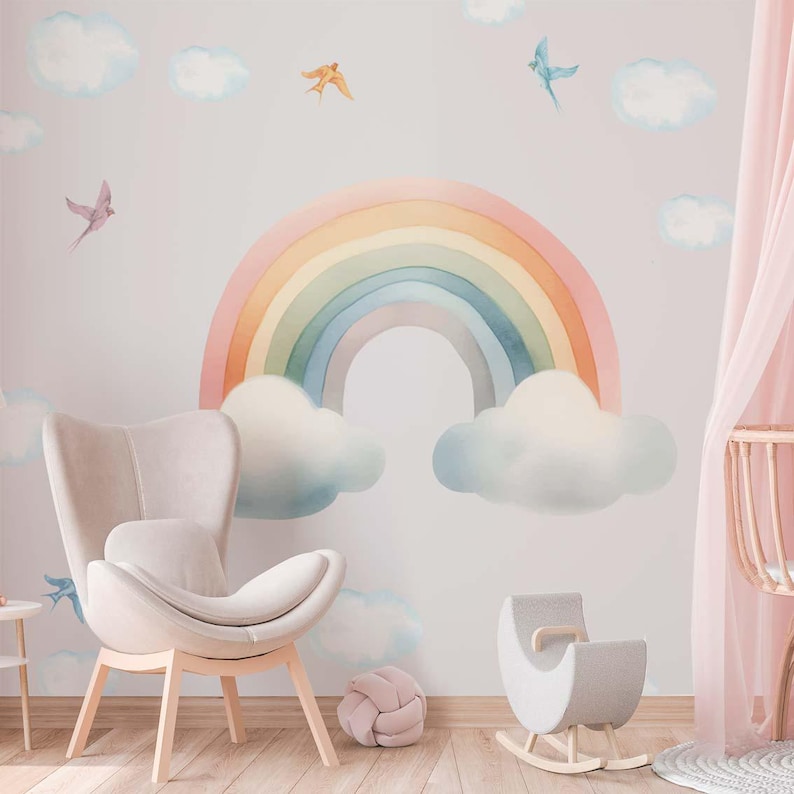 May include: A pastel rainbow with clouds and birds on a light pink wall. A rocking horse and a chair are in the foreground.