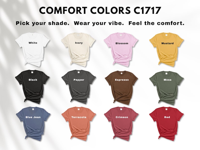 May include: A display of Comfort Colors C1717 t-shirts in various colors, including white, ivory, blossom, mustard, black, pepper, espresso, moss, blue jean, terracotta, crimson, and red. The text "Pick your shade. Wear your vibe. Feel the comfort." is at the top.