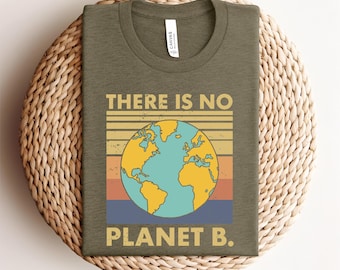 May include: Olive green t-shirt with a graphic of the Earth in yellow and blue, set against a striped background of yellow, orange, and blue. The text "THERE IS NO PLANET B" is printed above and below the graphic.