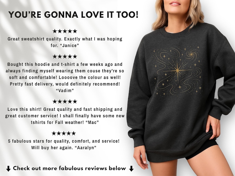 May include: Dark gray sweatshirt with a gold celestial design. The design features a central starburst with swirling lines and smaller stars. The text "YOU'RE GONNA LOVE IT TOO!" is at the top of the image.