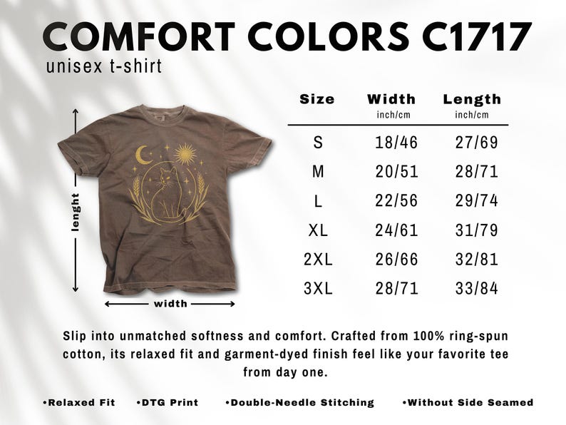 May include: Brown unisex t-shirt with a celestial cat graphic. The shirt features a crescent moon, sun, and wheat design. Sizes range from S (18 inches/46 cm width, 27 inches/69 cm length) to 3XL (28 inches/71 cm width, 33 inches/84 cm length).
