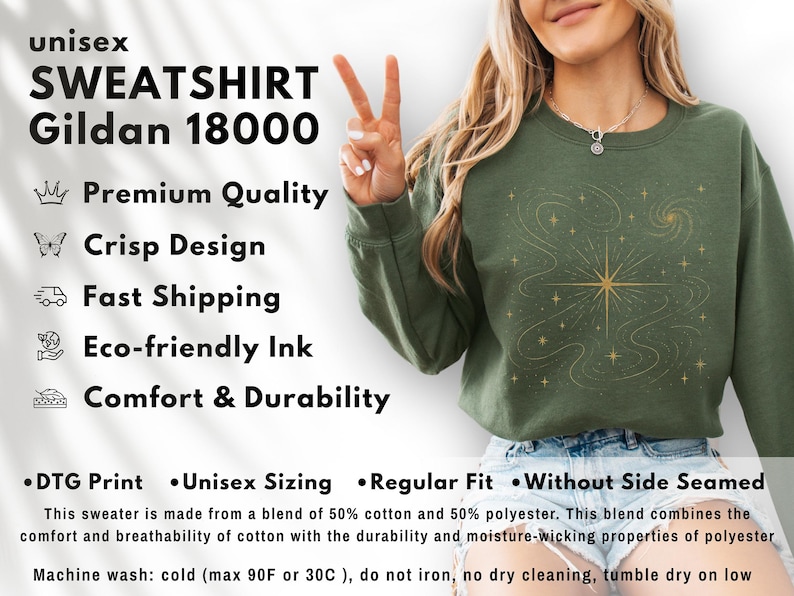 May include: Olive green unisex sweatshirt with a gold celestial design. The sweatshirt features the text "SWEATSHIRT Gildan 18000". The design includes a starburst and swirling lines. The sweatshirt is made of a blend of cotton and polyester.