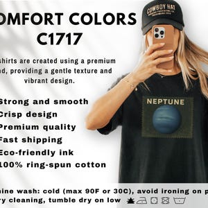 May include: Black t-shirt with a Neptune graphic. The shirt features the text "NEPTUNE" above a blue planet image. The image also includes the text "COMFORT COLORS C1717" and washing instructions.
