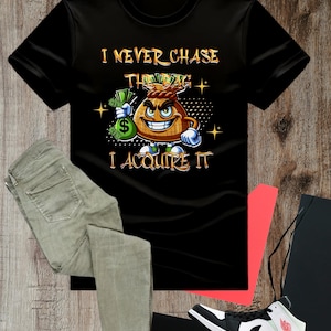 May include: Black t-shirt with a cartoon money bag wearing a crown and holding a bag of money. The text on the shirt reads "I never chase the bag I acquire it."