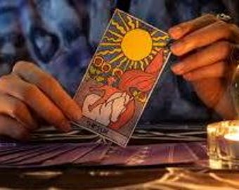 May include: A tarot card with a sun illustration in the center. The card is red and yellow with a sun in the center. The card is surrounded by a yellow border.