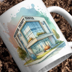 May include: White ceramic mug featuring a watercolor illustration of a physical therapy center. The building has large windows and a sign that reads "Physical Therapy Center." The design includes blue, green, and peach watercolor accents.