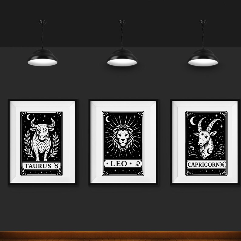 May include: Three black and white framed prints with zodiac signs. The first print features a bull with the text "Taurus ♉". The second print features a lion with the text "LEO ♌". The third print features a goat with the text "CAPRICORN ♑".
