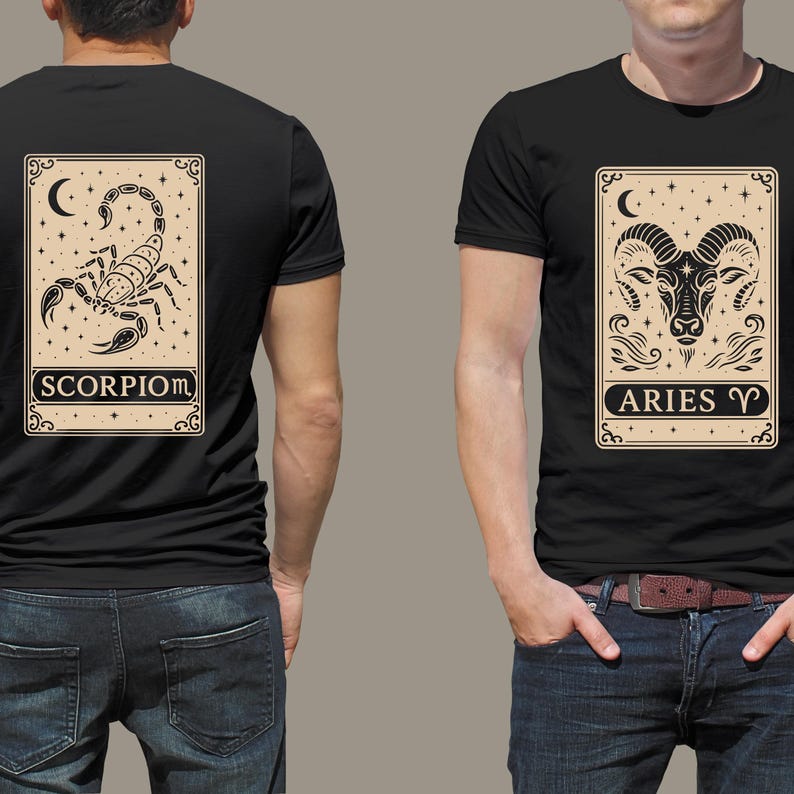 May include: Two black t-shirts with zodiac signs printed on the front. The left shirt features a scorpion with the text "SCORPIO" and the right shirt features a ram with the text "ARIES".